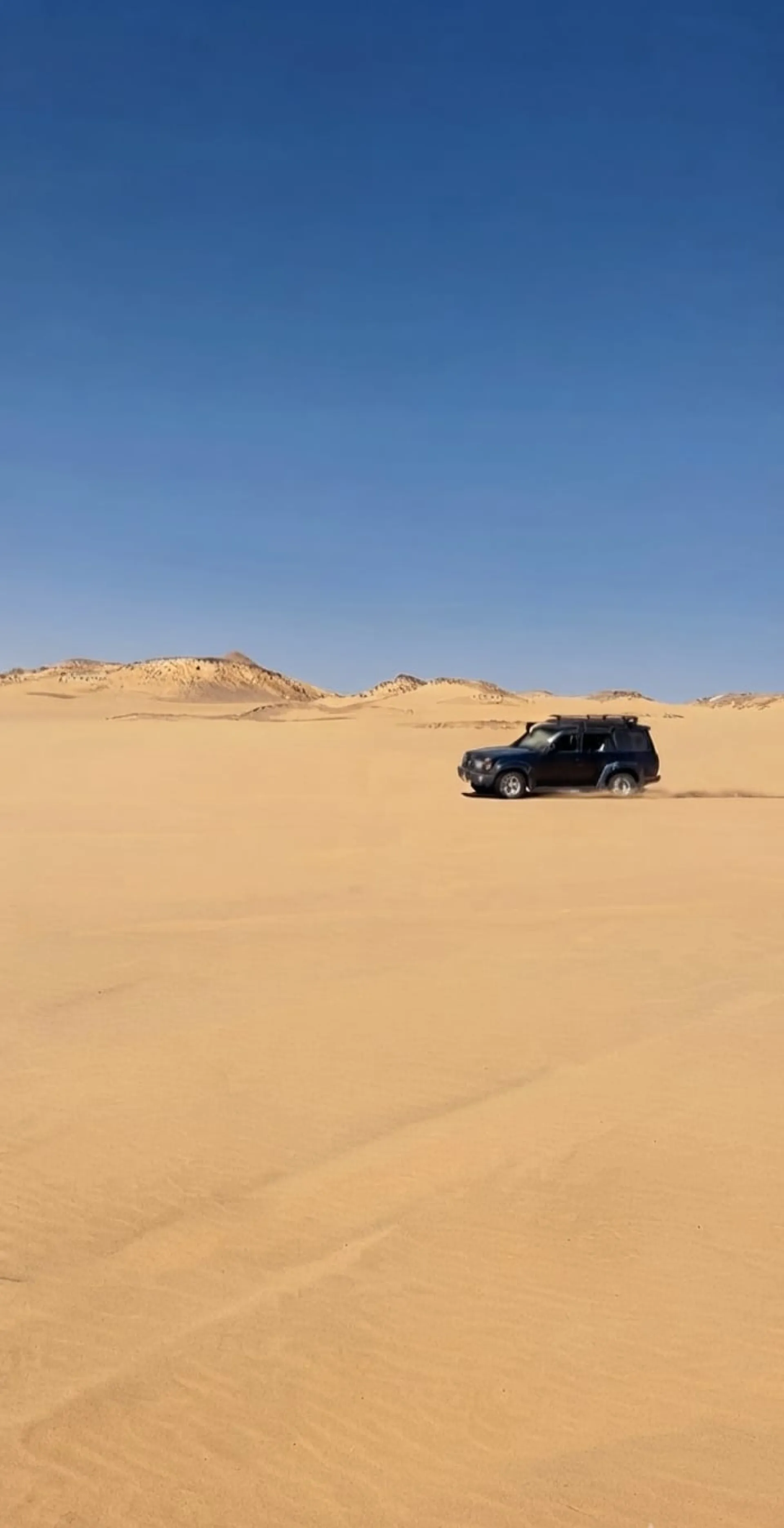 4x4 driving across the sand dunes of Egypt's Western Desert